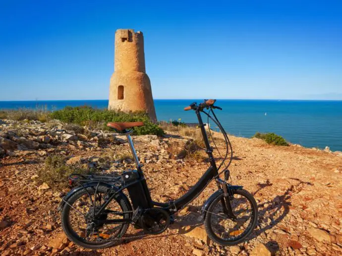 Electric bike in front of a stone tower