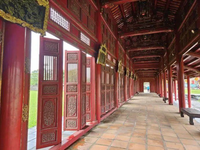 Walkway with red walls, doors and pillars