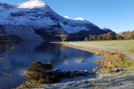 Lake surrounded by snow capped mountains
