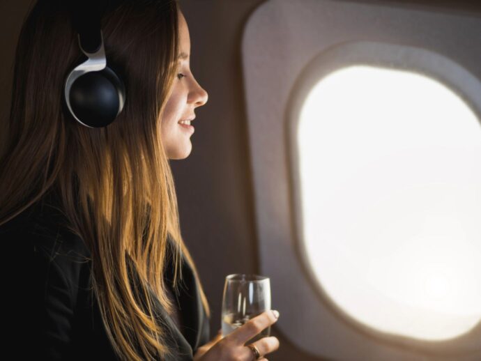 Woman with headphones on plane